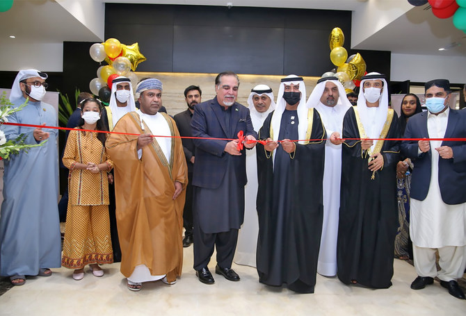 UAE Minister of Tolerance Sheikh Nahyan bin Mubarak Al-Nahyan (4R) and Sindh Governor Imran Ismail (2L) are cutting a ribbon to inaugurate a new visa center in Karachi, Pakistan, on November 28, 2021. 